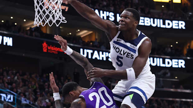 Mar 18, 2024; Salt Lake City, Utah, USA; Minnesota Timberwolves guard Anthony Edwards (5) dunks the ball against Utah Jazz forward John Collins (20) during the third quarter at Delta Center. 